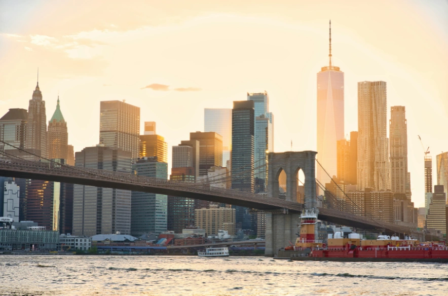 The Brooklyn bridge in front of skyline at sunset